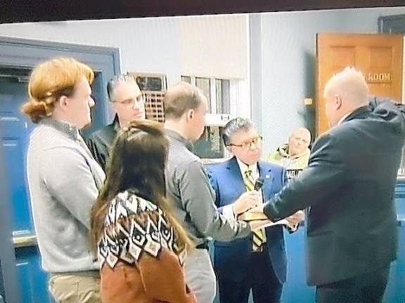 West Milford Councilman Kevin Goodsir, right, takes the oath of office for his second term surrounded by his family. The oath was administered by state Sen. Anthony M. Bucco, second from right, and Assemblyman Christian Barranco, second from left. Goodsir was chosen to be council president for 2023.