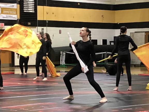 Some members also perform with wooden rifles. (Photo by Kathy Shwiff)