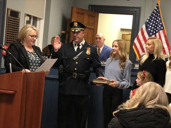 Mayor Michele Dale administers the oath of office to Police Chief Shannon Sommerville at the Township Council’s annual reorganization meeting Wednesday, Jan. 3. Sommerville has been acting chief for the past few months. He succeeds James DeVore, who retired effective Jan. 1 after serving as chief for about three years.