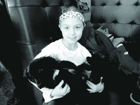 Mohawk House goes to the dogs for O.S.C.A.R. fundraiser O.S.C.A.R. volunteer Maya Vergalito, seven, of Stockholm, shows how good Tess the puppy is with children.