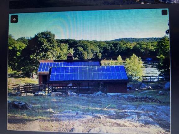 A barn at Two Pond Farm is covered with solar panels.