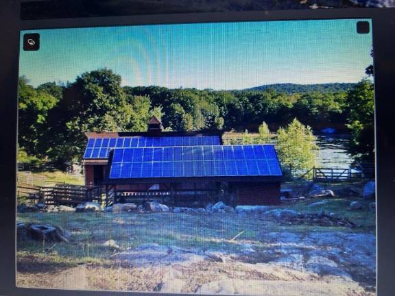 A barn at Two Pond Farm is covered with solar panels.