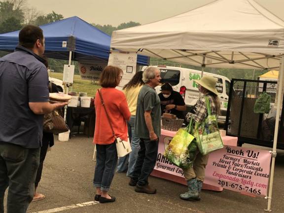 Customers form a line at the Empanada Lady stand.