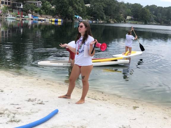 Going the distance Madi Storch, 19, of West Milford, head lifeguard at Lindy’s Lake, gives instructions before the Distance Swim. She and other lifeguards were on paddle boards in case any of the swimmers needed help or a chance to rest. (Photo by Kathy Shwiff)