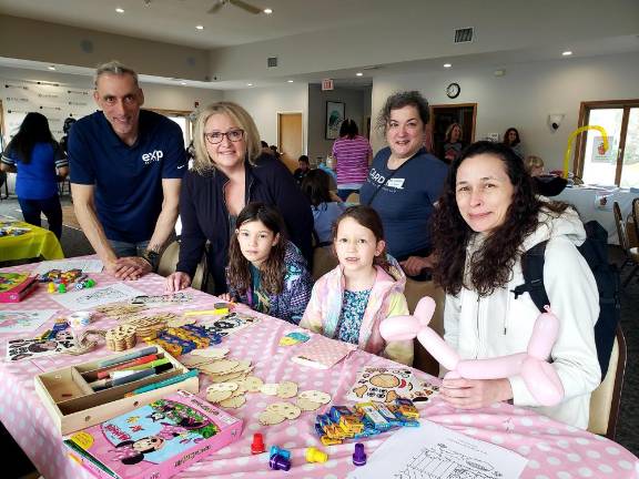 Event organizers Jeffrey Struck and Elizabeth Petros Santos, standing, along with West Milford Mayor Michele Dale, second from left, stop by the art activities station.