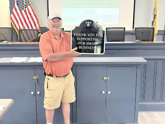 West Milford Environmental Commission Chair Steve Sangle holds a plaque he donated to the West Milford Economic Development Commission in backing efforts to support small businesses.