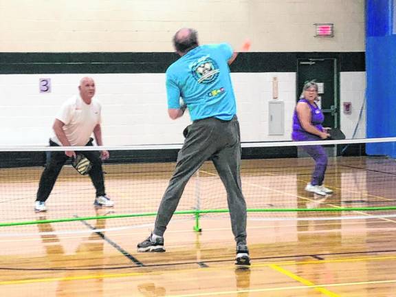 Jim Zajdel hits the pickleball toward Lorette Lenihan, who was playing with her husband, Rich. (Photo by Kathy Shwiff)