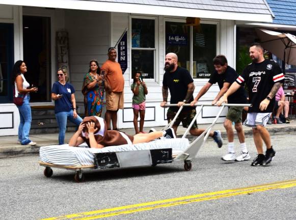 Bed race returns to village Pushing the Murphy’s Tavern & Restaurant bed carrying Della Martin are, from left, Steve Marino, Ralph Costanza and Bryan Martin. Murphy’s came in second this year after winning the race in 2013 and 2014, the last time it was held. (Photos by Fred Ashplant)