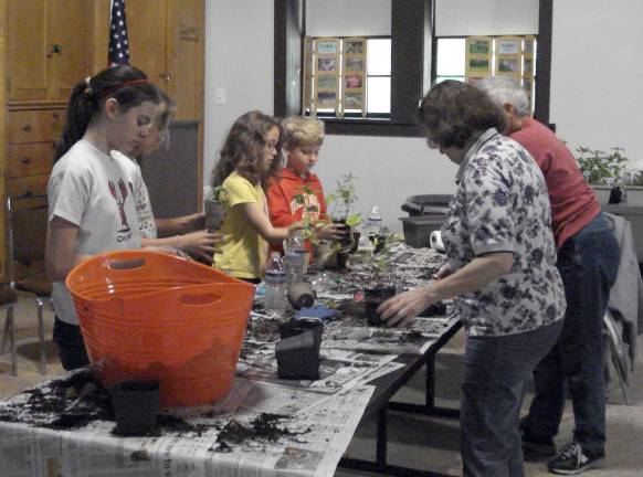 Young gardeners at NJBG&#x2019;s Children&#x2019;s Gardening Workshop are captivated as they plant veggies to take home under the guidance of NJBG&#x2019;s Nancy Cochrane. The workshop will be held on Sunday, May 19, from 1-3 p.m. at NJBG. Photo courtesy of NJBG