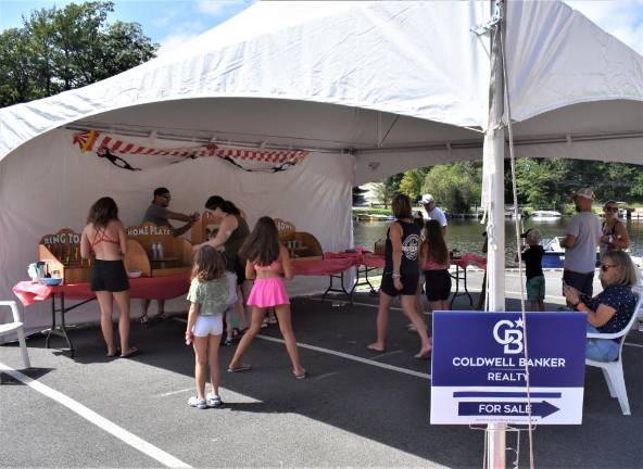 Games are set up under a tent. Children could win tickets to exchange for prizes.