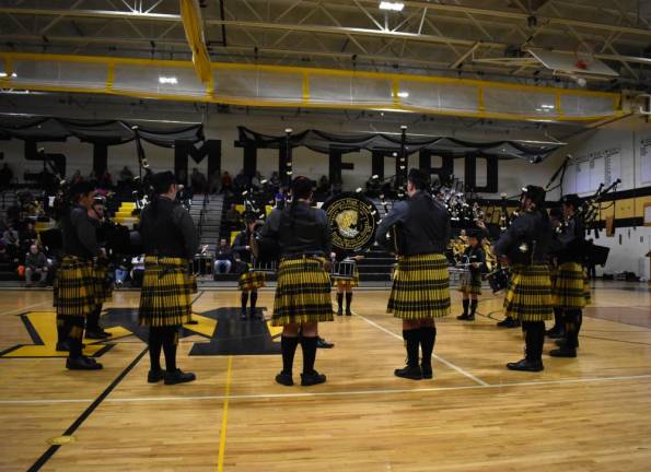 The Celtic Friars Pipe Band from St. Anthony’s High School play in a circle.