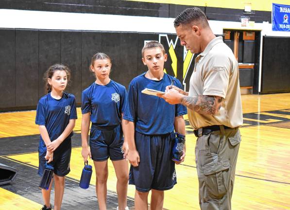Junior Police Academy grows Police Chief Shannon Sommerville marks cadets after physical training exercises.