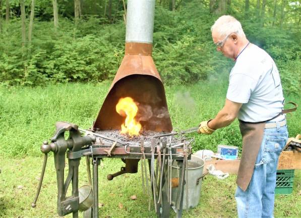 Wycoff Blacksmith Gaspar Lesznik conducts a field demonstration of 19th century metal work at the Long Pond Ironworks State Park in Ringwood on Saturday. Charles Kim photo.