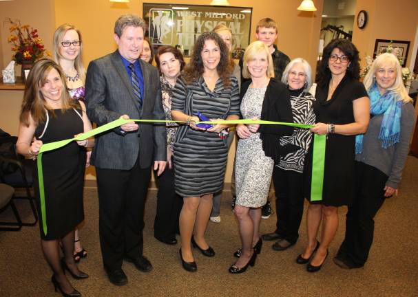 West Milford Physical Therapy Center relocates to Bald Eagle Commons Photos by Ginny Raue West Milford Mayor, Bettina Bieri, center, cuts the ribbon to open the new West Milford Physical Therapy Center. To the left and right of the mayor are Sean and Anne Kane, physical therapists and owners of the newly relocated facility, surrounded by their staff.