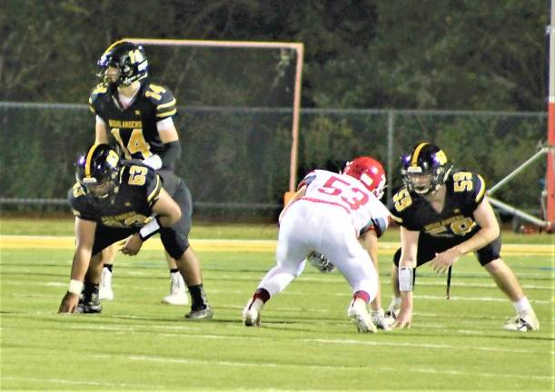 Highlanders quarterback Dylan Connors calls a play during the game Friday night.