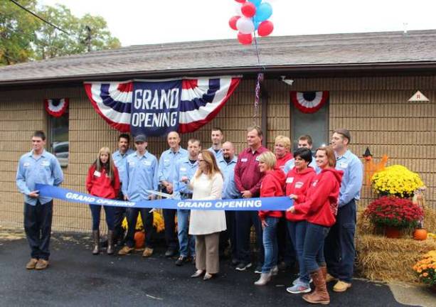 Photo by Ginny Raue West Milford Councilwoman CarlLa Horton does the honors, cutting the ribbon at the grand opening of the new facility for Mark Lindsay and Son Plumbing and Heating.