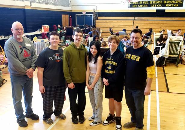 West Milford Animal Shelter Society president Paul Laycox, left, poses with members of the Macopin Middle School Student Council and seventh-grade science teacher Art Joecks, right. Student Council officers, from left, are eighth-graders Joe Casella, Andrew Spagnuolo, Madeline Park and Donald Stinziano.