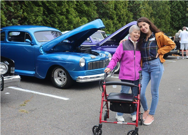 $!Activities Director Josie Webb poses with a resident during the Life-themed car show.