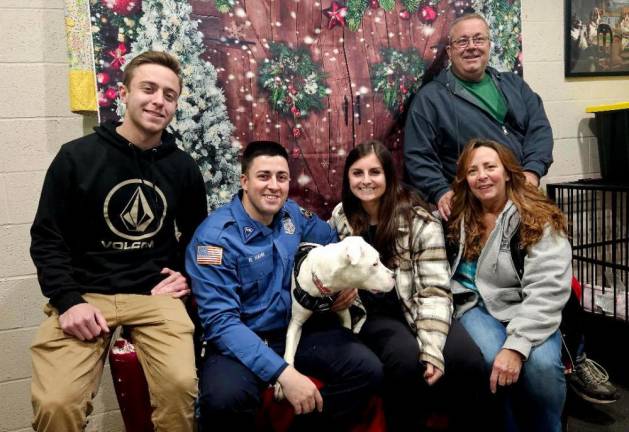 From left are Nick Hahn; Robert Hahn and his girlfriend, Lindsay; and the Hahns’ parents, Sherri and Joe. The family took home their new dog, Reina, on Dec. 5.