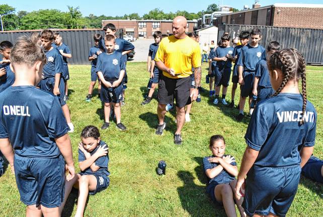 Junior Police Academy grows Cadets do sit-ups as part of the physical training.