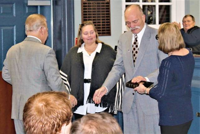 Republican Warren Gross takes the oath of office from State Sen. Joe Pennacchio, R-26, Monday night.