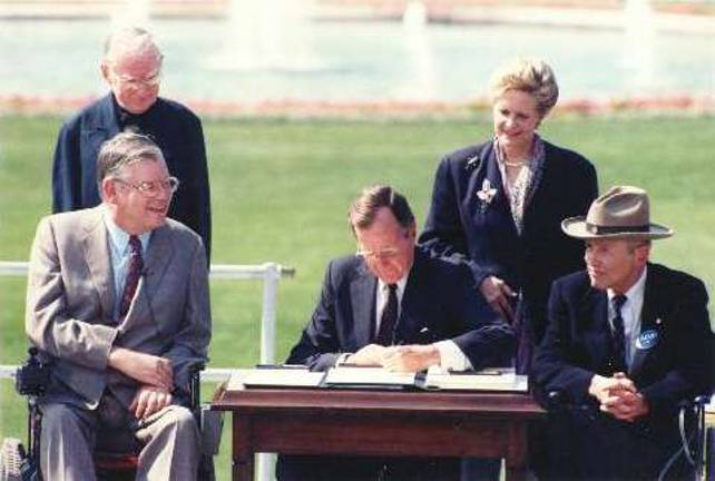A long road traveled, more to go Source: www.adata.com President George H.W. Bush is seen here signing the Americans With Disabilities Act (ADA) into law on July 26, 1990.