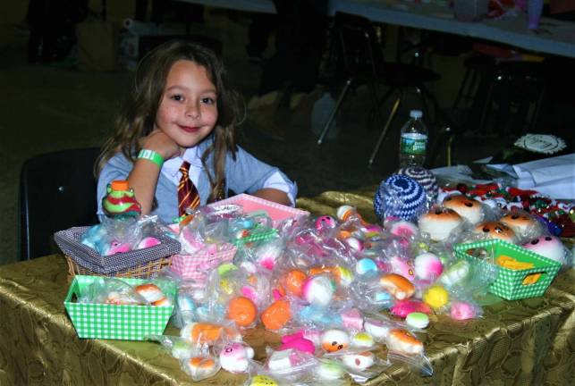 Melisa Roci, 8, mans a table of goods at the Spooktacular event Saturday at West Milford High School.
