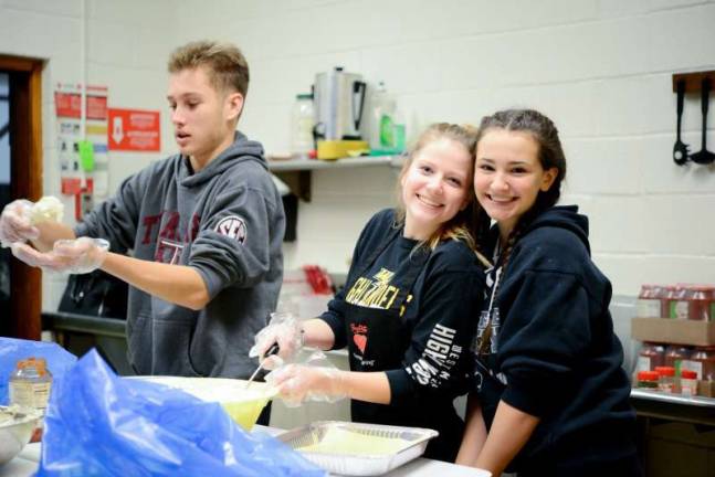 Youth ministry provides meals and more for families in need Photos by Patricia Keller Mitchell Brijbag, Aleach Coscia and Gabby Farias, and other members of St. Joseph's Church's Youth Ministry, make lasagna for families in need.