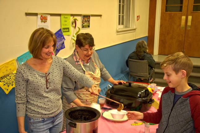 The very best chili around Photos by Don Webb May I have some more.... Vivian Smith serves Ryan Davis more delicious chili.