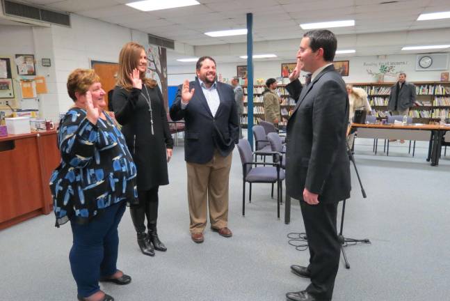 School trustees sworn in; board president appointed Photos by Patricia Keller School board trustees, from left, Lynda Van Dyk, Nicole Fritz and Ray Guarino are sworn in Tuesday by board attorney Joseph Roselle.