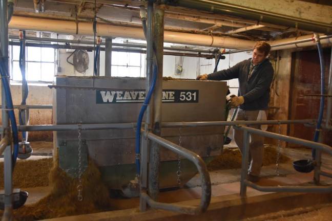 Neal Southway, a high school senior, doing farm chores between online classes