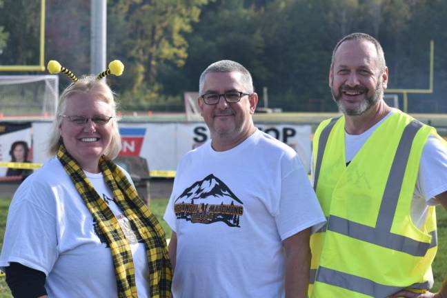 Aaron Tornow, right, chairman of the Highlander Marching Classic, poses with Leslie and Christopher DeWilde, who also are members of the West Milford Band Parents Organization.