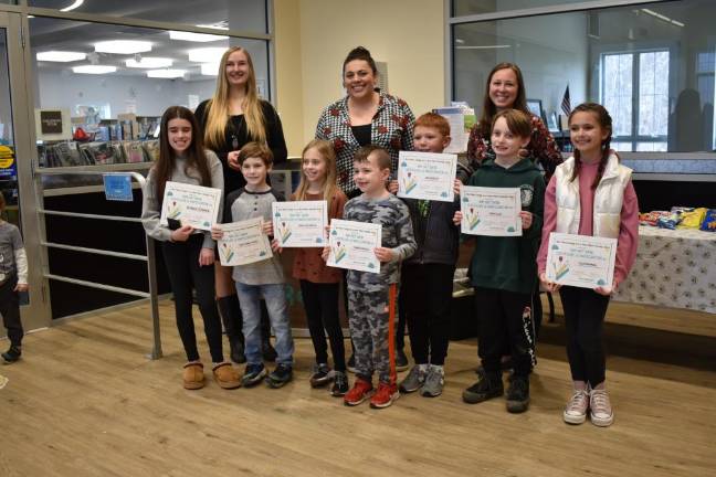 Several of the student artists show their certificates of participation, which were presented by their school art teachers.