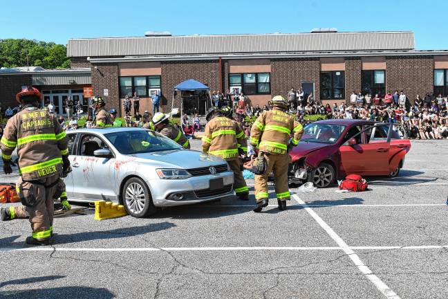 Simulated crash meant as warning First-responders assist with a simulated two-car vehicle crash Tuesday, June 3 in front of West Milford High School. (Photos by Rich Adamonis)