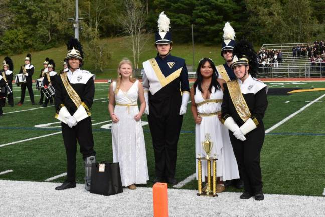 West Milford Highlander Marching Band members Colin Iwaszczuk, left, and Natalie Casella, right, flank members of the Vernon Township High School band during the trophy presentation.