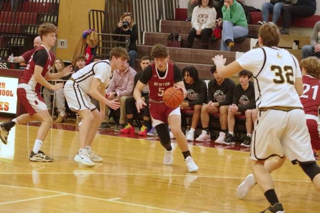 Newton’s Dominic Celi maneuvers the ball on the court.