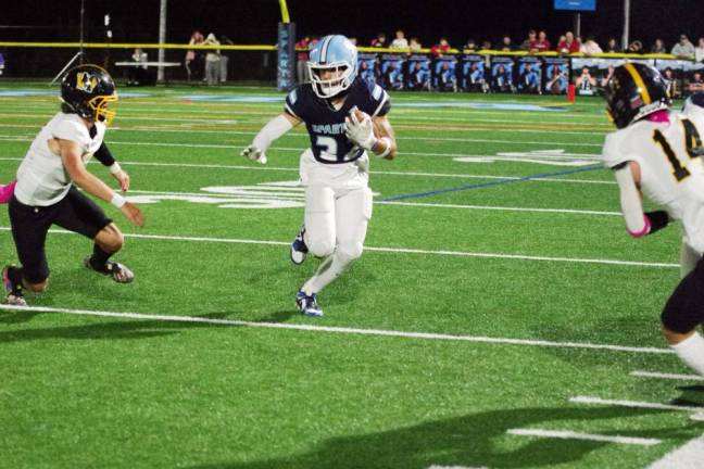 Sparta running back Josh Brancy maneuvers the ball between West Milford defenders.