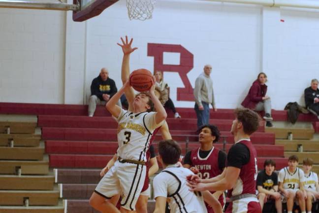 West Milford’s Nash Appell takes the ball to the hoop during a shot. He scored two points.