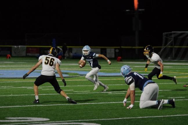 Sparta quarterback Shane Hoover on the run. He threw the ball for a total of 298 yards, resulting in five touchdowns. He also kicked four points after touchdowns.