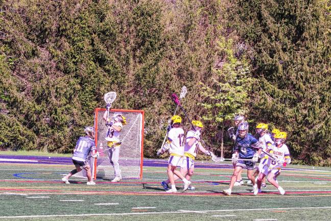 Sports roundup: Falcons advance to MCT semifinal Jefferson goalkeeper Jamison Reid (13) intercepts the ball with his crosse, preventing a Pope John goal April 28. He made 12 saves, but the Lions won, 12-4.