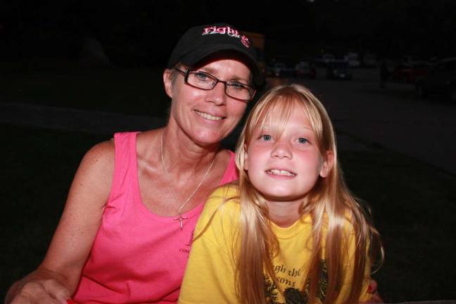 Doo-woping with the Streets of the Bronx Marlene Terhune, Recreation Program specialist with West Milford Community Services and Recreation, was on the job as concert organizer but brought along her grandchildren for a night of fun. Pictured here is Terhune with her granddaughter Elyse.