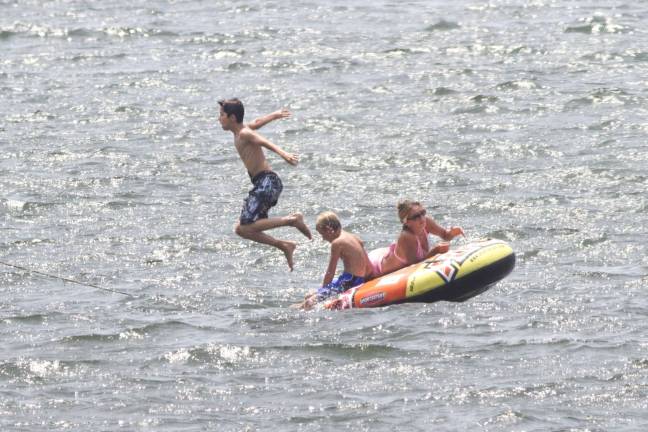 Cottage Cove residents fighting for their neighborhood Kids play on Greenwood Lake in this file photo. Residents of Cottage Cove on Greenwood Lake want the township to deny a property owner the use of a liquor license for a business, which they say will make their neighborhood less safe.