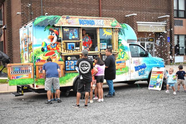 Community gathers for National Night Out Kona Ice offers flavored shaved ice and traditional ice cream.