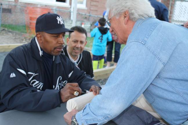 Yankee Willie Randolph kicks off the Little League season This gentleman brought an old Yankee jacket for Willie Randolph to sign.