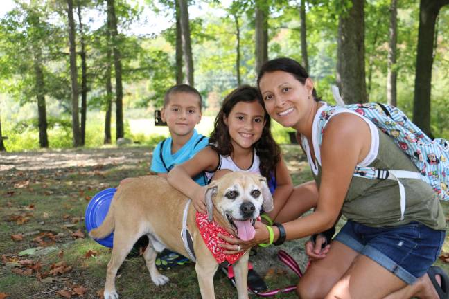 Pooches strut their stuff in Walk-a-Dog-athon Enjoying the sunny day with Bugsy are, left to right: Paul Jael and Heather Milano of Monroe.
