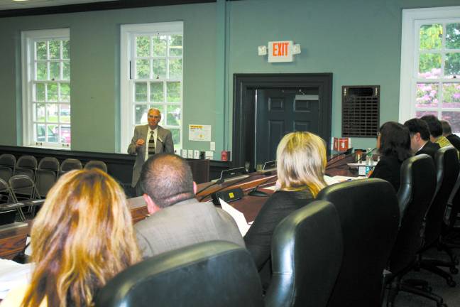 Photo by Linda Smith Hancharick Interim township Administrator Robert Casey addresses the township council on Wednesday regarding the budget. The council approved the final budget and instructed Casey to continue cutting.