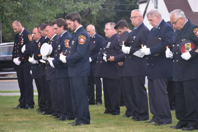 Photos of 9/11 Memorial Ceremony West Milford firefighters bow their heads during the ceremony.