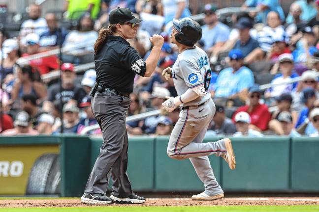 Pawol makes baseball history Umpire Jen Pawol, left, signals Miami Marlins' Javier Sanoja out at first base in the eighth inning of the first baseball game of a doubleheader against the Atlanta Braves on Saturday, Aug. 9 in Atlanta. (AP Photo/Colin Hubbard)