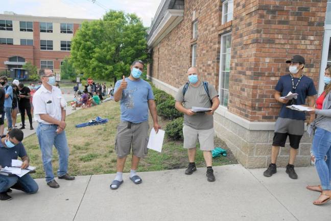 From left, with thumbs up, Juan Martin arrived around 2 a.m., and Todd Tracy arrived at 1:30 a.m. (Photo by Vera Olinski)