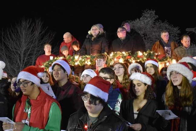 The West Milford High School Concert Choir performs at the ceremony. Mayor Michele Dale, center, and members of the Township Council stand on a raised platform behind the choir. (Photo by Rich Adamonis)